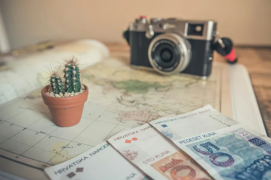 Travellers reviewing shared expenses on a phone